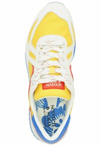 Yellow mesh sneaker with white and red accents, blue sole, and decorative inner lining pattern. Features laces and a logo tag.