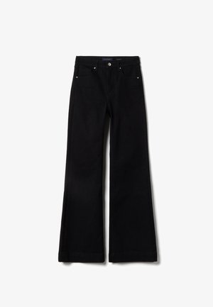 Black flared jeans made of denim, featuring five pockets, a button closure, and contrasting stitching. Smooth texture with a clean finish.