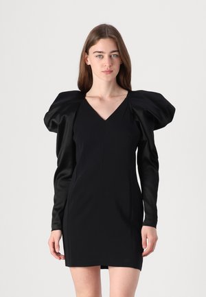 Black dress with a fitted silhouette, V-neck, and dramatic puff sleeves in a smooth, shiny fabric. Minimalist design with no patterns or accents.