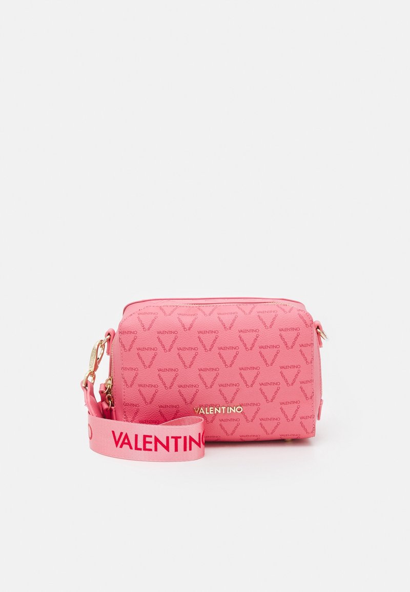 Pink leather handbag with patterned texture, featuring a zip closure, gold hardware, and a detachable strap labeled "VALENTINO."