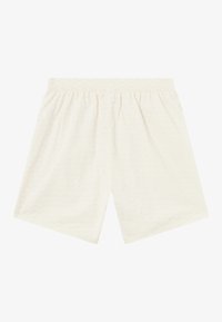 Light cream-colored shorts made of soft fabric, featuring an elastic waistband and a subtle repeating pattern throughout.