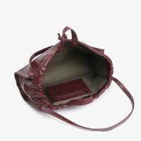 Open maroon leather tote bag with wide strap showing empty olive fabric interior and small inner zip pocket.