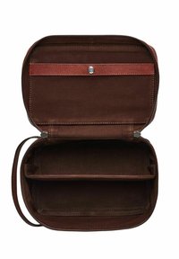 Bruine stoffen tas met een ritssluiting, met twee compartimenten en een kleine schouderriem. De binnenkant is gevoerd en beschikt over een met een knoop beveiligd vak.