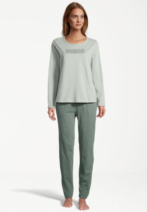 Light green long-sleeve top with “SHINE” text; paired with matching green pants. Both made of soft, breathable fabric. Simple design.