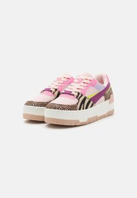 Trendy sneakers featuring a mix of pink mesh and animal print materials. Thick white soles and colored accents in purple and green.