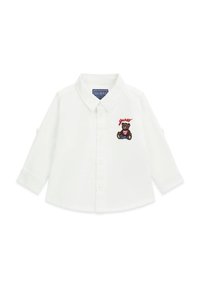 Camicia bianca a maniche lunghe con colletto button-down, caratterizzata da un orso ricamato e testo "guess" sul petto sinistro. Tessuto di cotone liscio.