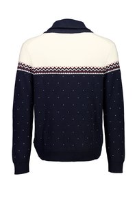 Marineblauwe gebreide trui met crème schouderstuk, voorzien van een zigzagpatroon en witte polkadots. Geribbelde manchetten en zoom zorgen voor een nette afwerking.