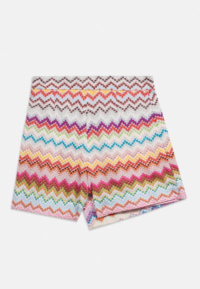 Shorts tricotés multicolores avec des motifs en zigzag horizontaux rose, bleu, orange, vert, violet et blanc sur un fond blanc.