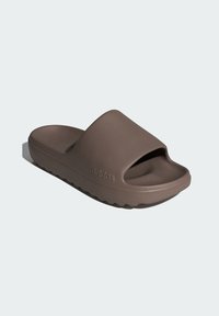 Brown rubber slide sandal with an open design, thick strap, textured sole, and subtle branding on the outer side.