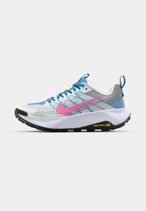 Nike Laufschuhe mit einem weißen synthetischen Obermaterial, blauen Akzenten, einem pinken Swoosh und einer schwarzen Gummisohle mit strukturiertem Profil für besseren Halt.