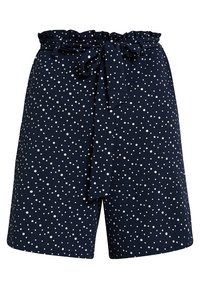 Granatowe szorty z falbanką na pasku i wiązaniem, zdobione białym wzorem w kropki. Wykonane z miękkiej, teksturowanej tkaniny.