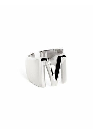 Silver ring with chunky band featuring a prominent, angular 'M' design. Smooth texture with polished finish and contrasting black interior.