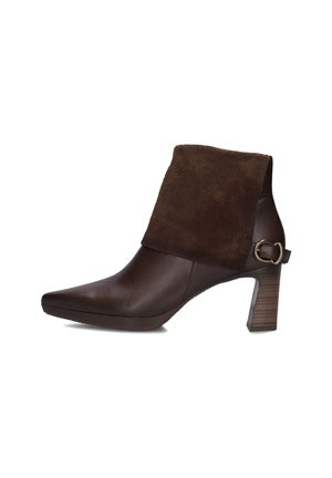 Ankle-high brown leather boot with folded dark brown suede cuff, pointed toe, stacked block heel, and small buckle detail on the side.