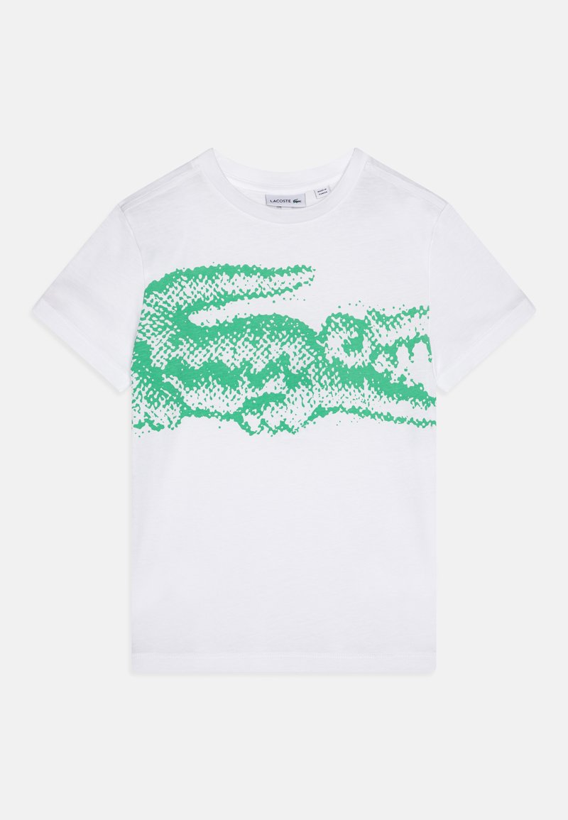 T-shirt en coton blanc avec un grand graphisme de crocodile texturé vert sur le devant. Manches courtes et design à col rond.