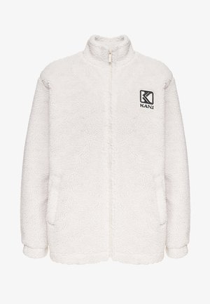 Veste en polaire blanche avec un col haut, fermeture éclair à l'avant et deux poches latérales. Présente un petit logo noir sur la poitrine.