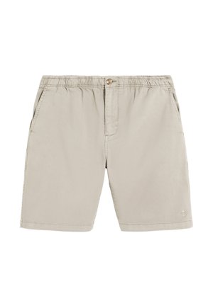 Pantalones cortos beige con cintura elástica con cierre de botón, bolsillos laterales y un pequeño logo de calavera y huesos cruzados cerca del dobladillo inferior en la pierna derecha.