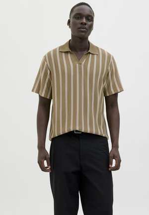 Short-sleeve, brown striped polo shirt with a collar and a v-neck design. Paired with black trousers, showcasing a relaxed fit.