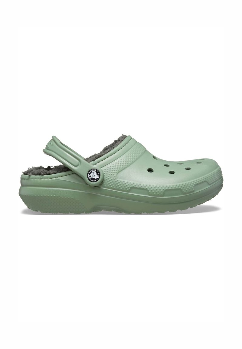 Light green clog made of synthetic material, featuring a textured design, ventilation holes, and a fuzzy gray lining. Adjustable back strap included.