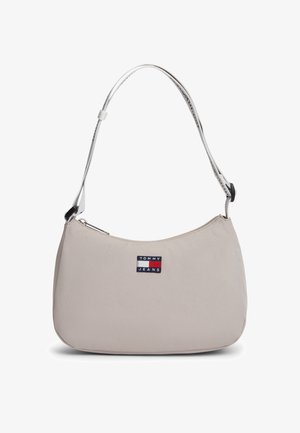 Beige nylon shoulder bag with a rounded shape, silver strap, and a small embroidered logo patch featuring red, white, and blue colors.