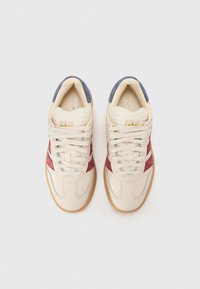 Cream sneakers with maroon and blue accents, textured leather upper, rubber gum sole, and traditional lace-up design.