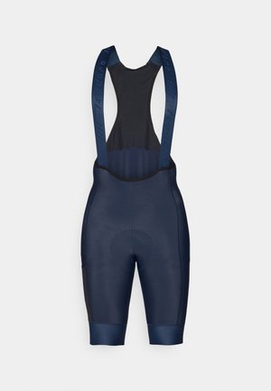 Cuissards de cyclisme bleu marine avec un haut en maille noire, zone de siège rembourrée, ouvertures pour les jambes élastiques et bretelles siglées pour un maintien sécurisé et un confort optimal.