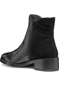 Black ankle boots with a smooth leather finish and suede accents, featuring a side zipper and a low block heel.