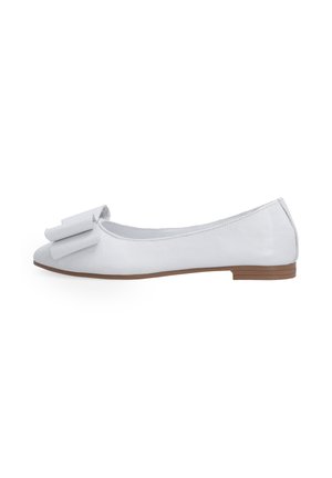 White leather ballet flats with a rounded toe, a large bow detail on the front, and a low brown stacked heel. Smooth texture throughout.
