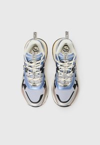 Blue mesh sneakers with silver accents, black and white details, and a textured sole. Features prominent branding on the tongue and heel.