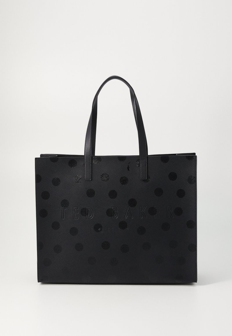 Sac fourre-tout noir avec des pois ronds en relief, logo "TED BAKER" embouti, doubles poignées plates et une forme rectangulaire structurée.