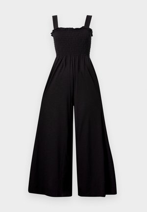 Black jumpsuit with wide legs, smocked bodice, and thin, adjustable straps. Made from a lightweight fabric with a smooth texture.