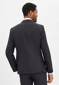 Dark gray suit jacket with a single vent at the back, featuring a notched collar, long sleeves, and buttoned cuffs. Smooth fabric texture.