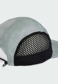 Berretto grigio chiaro con retro in rete nera, visiera curva e regolazione con fascetta. Il materiale sembra leggero e traspirante.