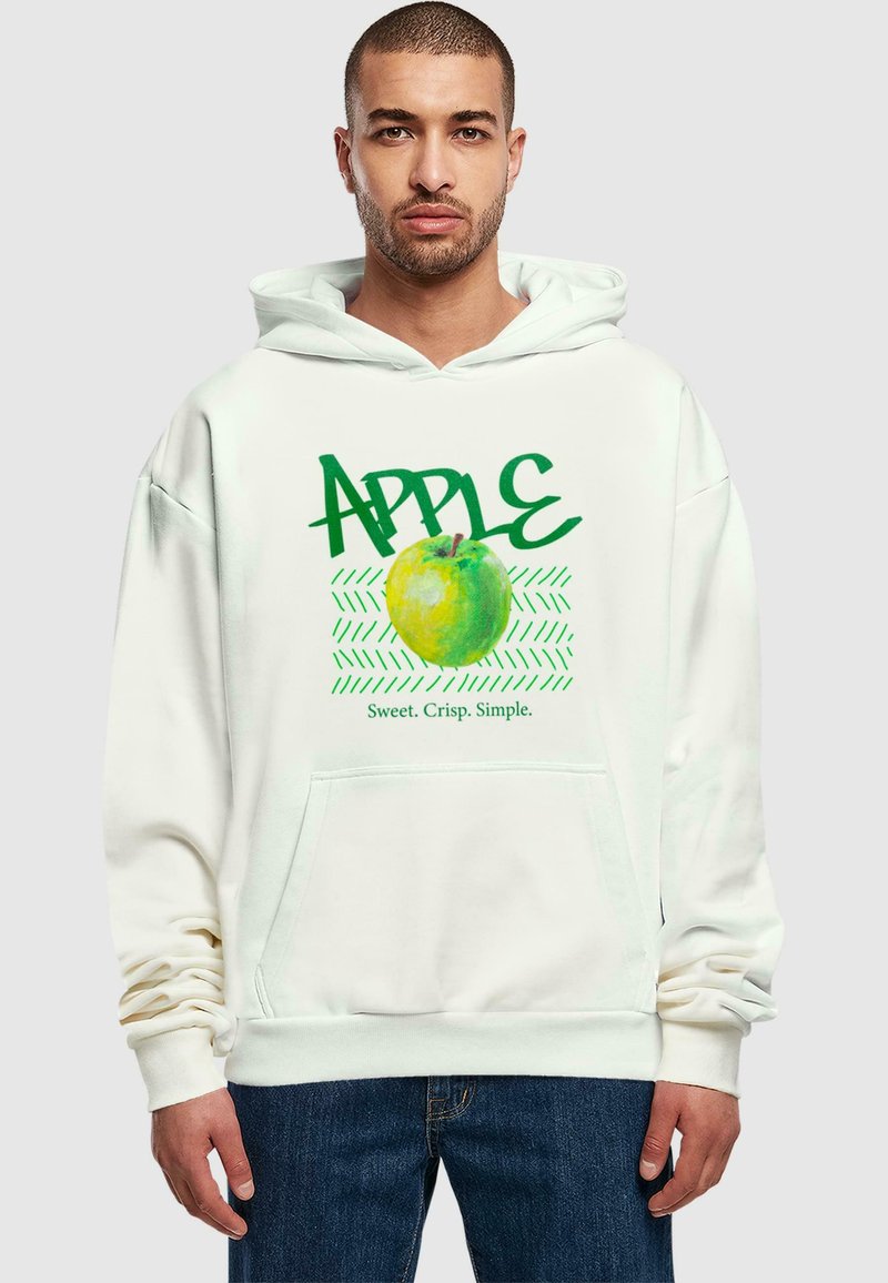 Felpa bianca con un grafico di una mela verde con la scritta "APPLE" in bold verde e "Dolce. Croccante. Semplice." in un testo più piccolo sotto.