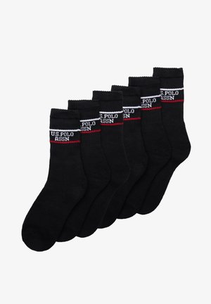 Calze in cotone nere, con un colore uniforme, bordi a coste e una fascia con logo bianco e rosso con "U.S. POLO ASSN." su ogni calza.