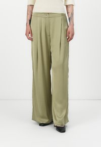 Light olive green wide-leg pants with pleats, made from a smooth material, featuring a button closure and side pockets.