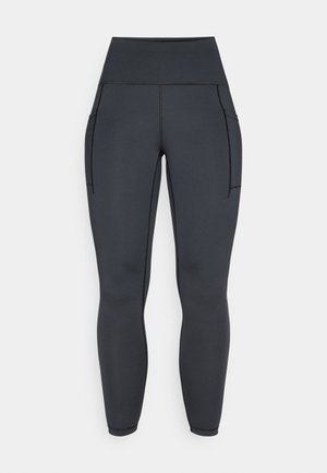 Leggings noirs taille haute en tissu extensible et lisse. Avec deux poches latérales et des coutures contrastées le long des coutures.
