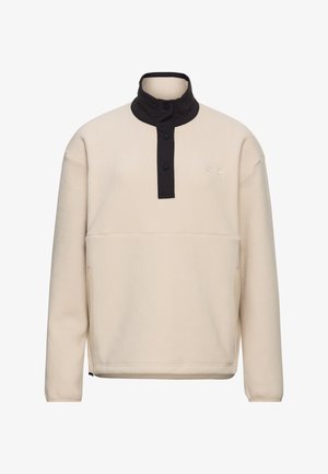 Roomkleurige fleece trui met een zwarte drukknoopsluiting en kraag. Voorzien van een buidelzak en een gladde textuur, geschikt om meerdere lagen mee te dragen.