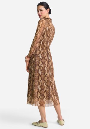 Long, brown, snake-print dress with a ruffled neckline, long sleeves, and a flared hem, paired with light green flat shoes.