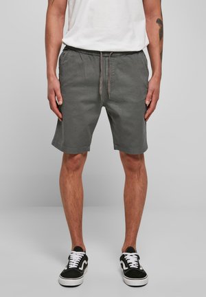 Shorts en coton gris avec une taille élastique, fermeture à cordon de serrage et poches latérales, offrant une coupe décontractée et des ourlets manchonnés.