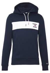 Granatowa bluza z kapturem z białym paskiem na klatce piersiowej, przednią kieszenią, białymi sznureczkami i logo "Tommy Jeans" na lewej piersi i mankiecie.