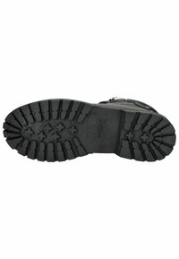 Semelle de botte en caoutchouc noir avec un design de tread texturé, comportant de profondes rainures et des motifs en étoile pour une meilleure adhérence et traction.