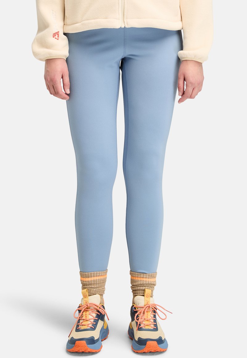 Ljusblå leggings i ett stretchigt material, åtsittande design, slätt tyg, i kombination med flerdimensionella sportskor och ribbade strumpor.