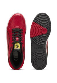 Sneaker in pelle rossa con accenti neri, design perforato e suola in gomma con motivo circolare e logo del marchio. Incluso emblema Ferrari.