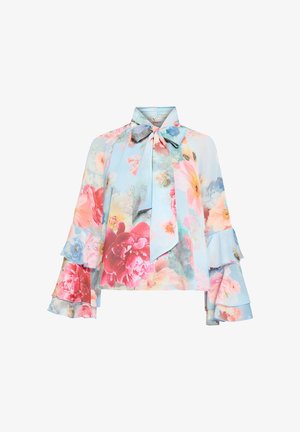 Kwiecista bluzka na pastelowo niebieskim tle, z falbanami na rękawach, kołnierzykiem z kokardą oraz żywymi różowymi, czerwonymi i niebieskimi wzorami kwiatów. Jedwabista tekstura.