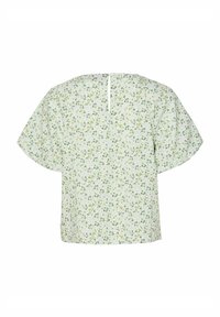 Blomstret top i lysegrøn stof. Korte, brede ærmer og en nøglehul-lukning bagpå. Har et struktureret mønster med små blomster.
