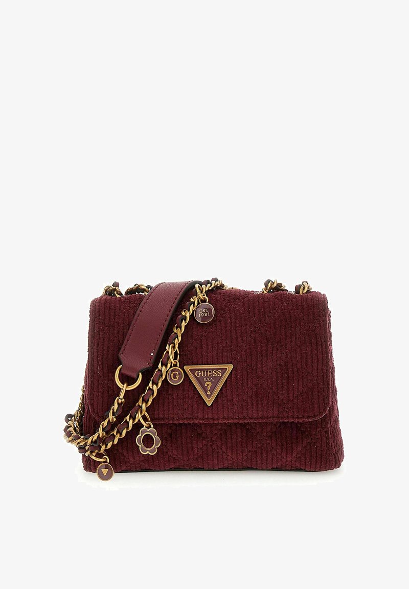 Sac à main en velours côtelé bordeaux avec quincaillerie dorée, arborant un logo en triangle, une bandoulière en chaîne et des charms décoratifs. Forme carré avec fermeture à rabat.