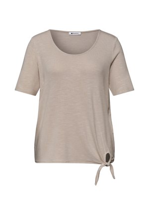 Beiges Kurzarmhemd mit rundem Ausschnitt und kleinem Knoten unten rechts.