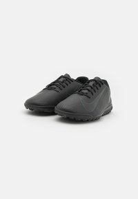 Black athletic shoes with textured stripes, featuring a sleek design, low profile, laces, and rubber soles for traction. Light blue accent detail.