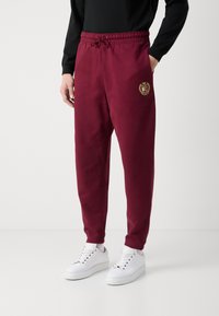 Tommy Jeans CREST - Trainingsbroek - deep rouge