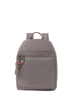 Gray Hedgren backpack with front zipper pocket, padded straps, and branded keychain hanging from zipper pull.
